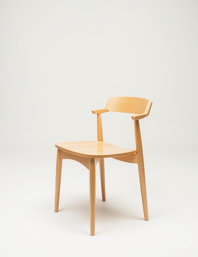 A light maple dining chair with a clean, minimalist design.